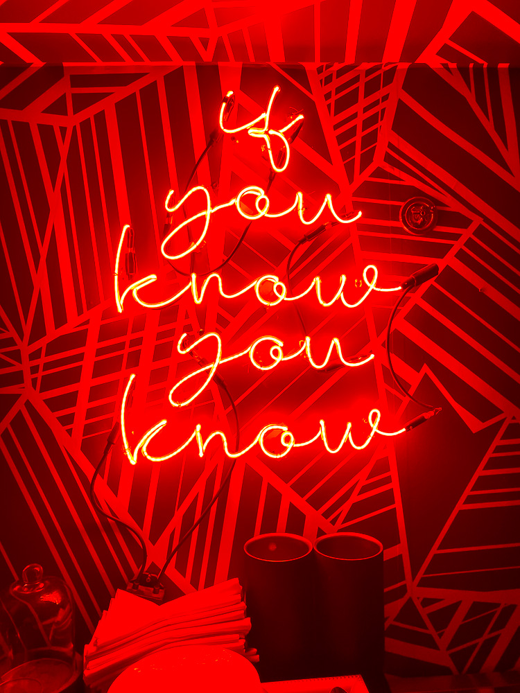 speakeasy sign reading "if you know you know" at Bungalow downtown Houston.
