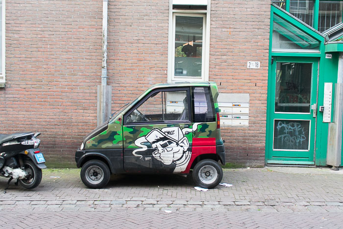 small car in alleyway in central Amsterdam, The Netherlands