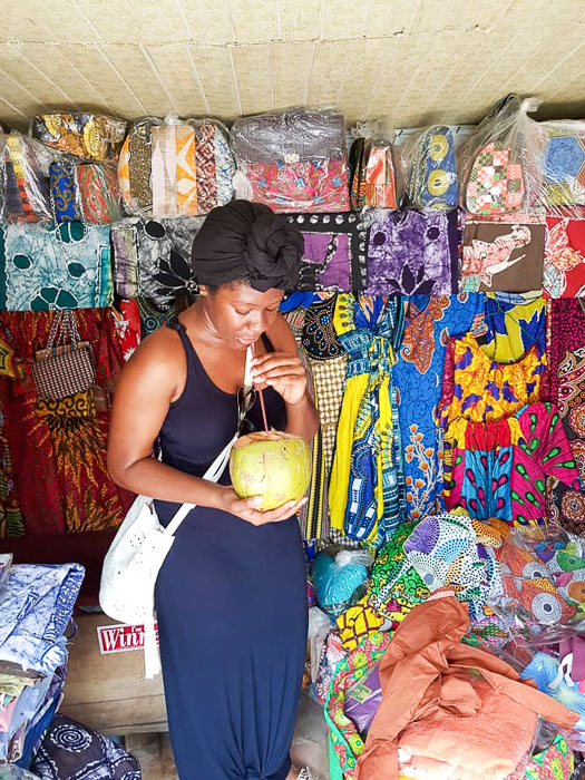 Dash of Jazz drinking fresh coconut water at Lekki Market, Lagos, Nigeria