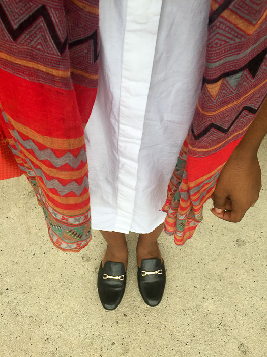 white shirt dress, multi-colored scarf, and black leather mules