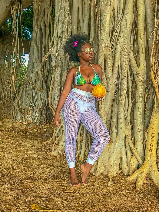 Jazzmine leaning against tree on Waikiki Beach