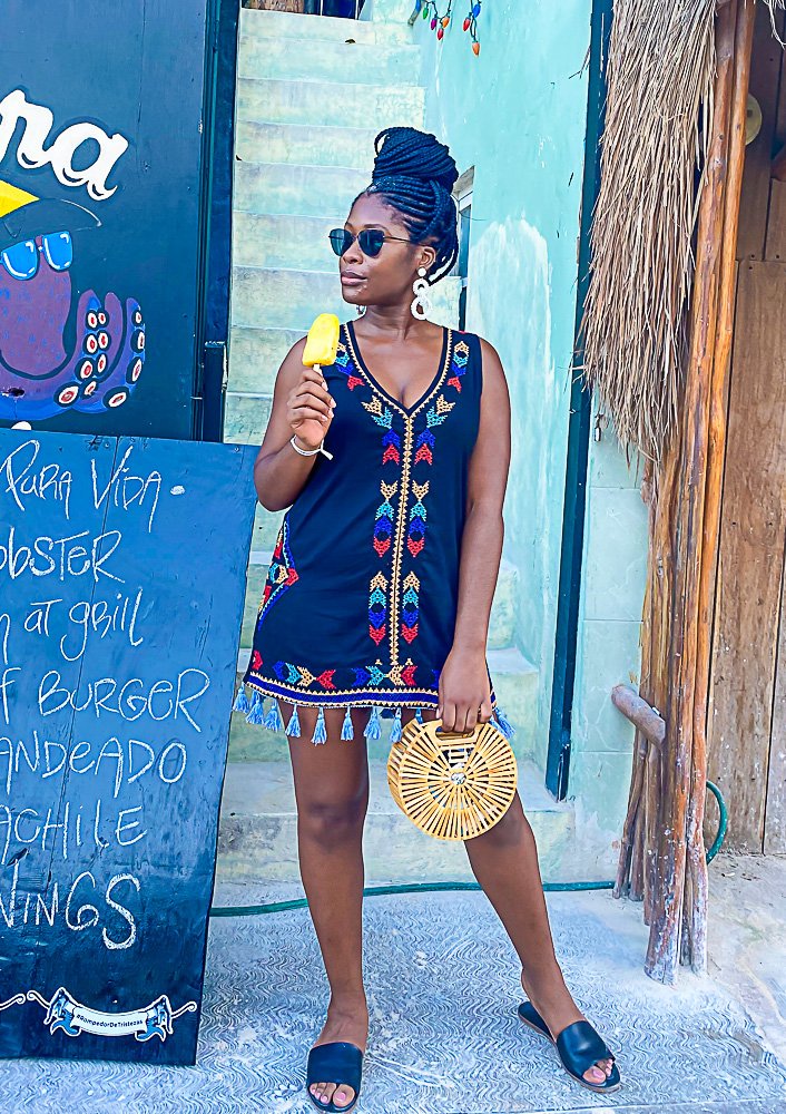 Jazzmine holding yellow paleta in front of Isla Holbox restaurant