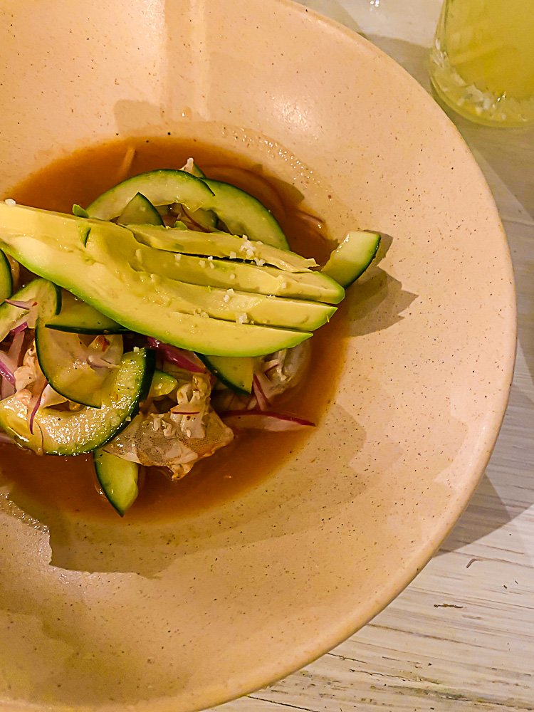 aguachile with avocado and flaky salt in ceramic bowl