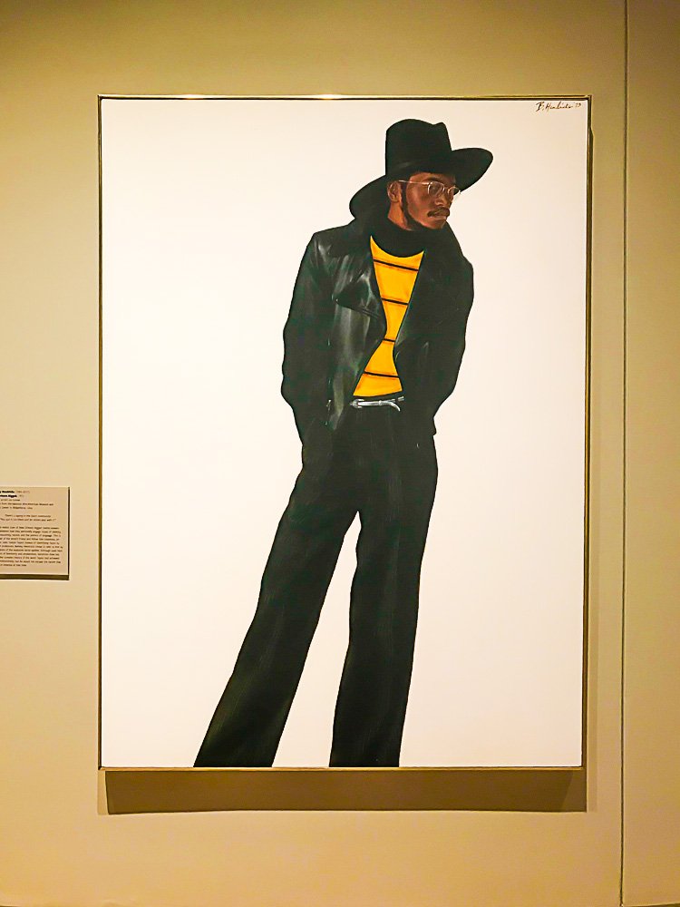 framed painting of a Black man wearing gold rimmed glasses at National Museum of African American Culture and History in DC.