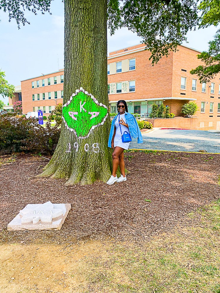 Jazzmine standing next to AKA tree.