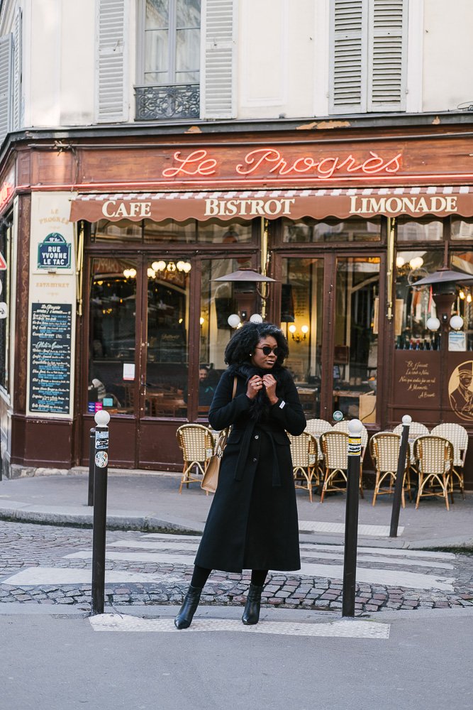 Jazzmine standing in front of Le Progres Cafe in Montmartre.