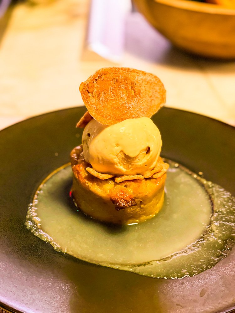 cinnamon toast crunch bread pudding topped with ice cream in pool of creme anglaise at Michele's DC.