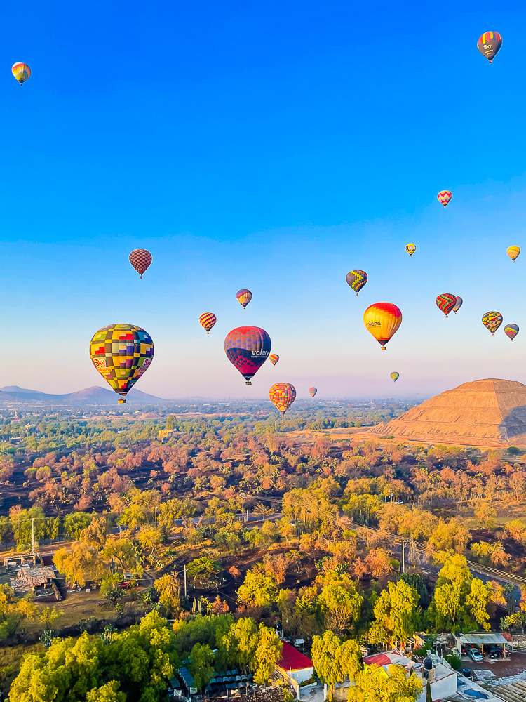 flying hot air balloons above town near Teotihuacan, Mexico.