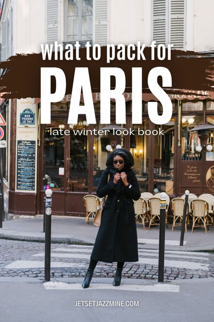 Jazzmine standing in front of Parisian cafe clutching the collar of a black coat with text overlay "what to pack for Paris late winter look book".