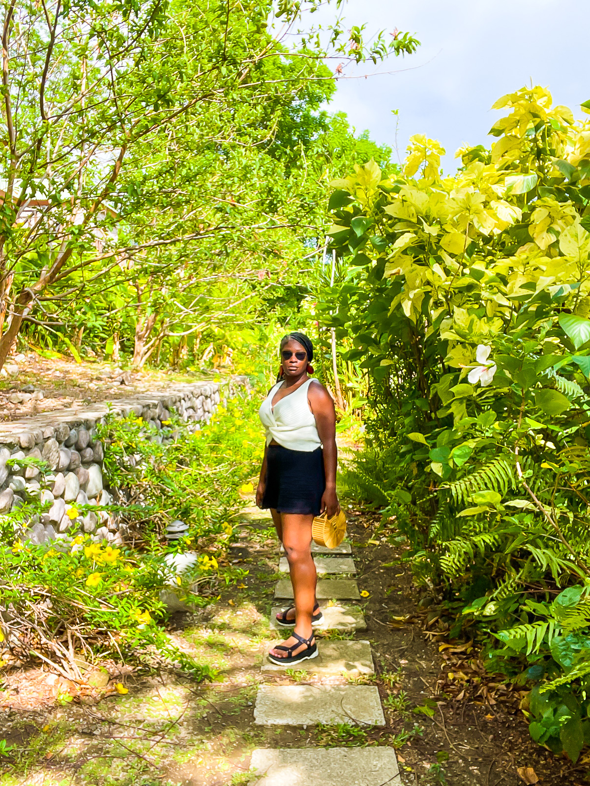 Jazzmine standing in a tropical garden on Caribbean island vacation.