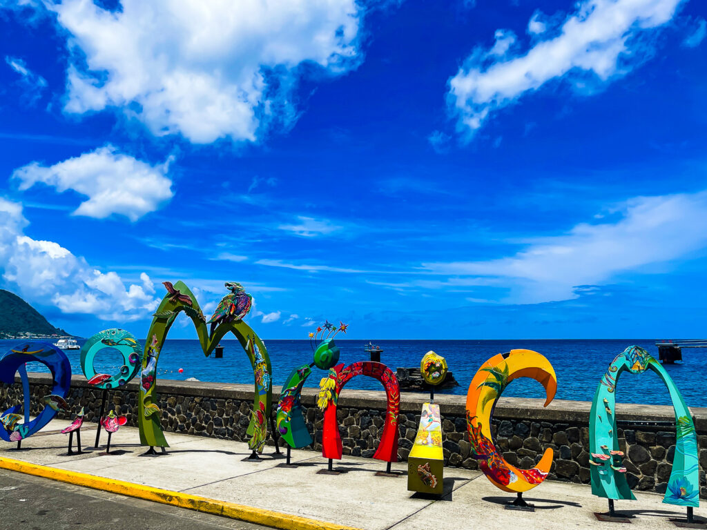 tall colorful metal sculptures that spell out DOMINICA along the seawall at Dominica's cruise terminal.