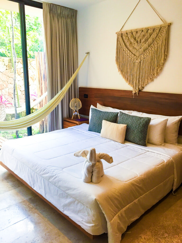 queen bed garden deck view room at Amaka Calma Riviera Tulum eco resort.