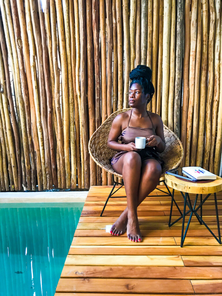 Jazzmine drinking morning coffee on vacation in Tulum at Amaka Calma boutique hotel.
