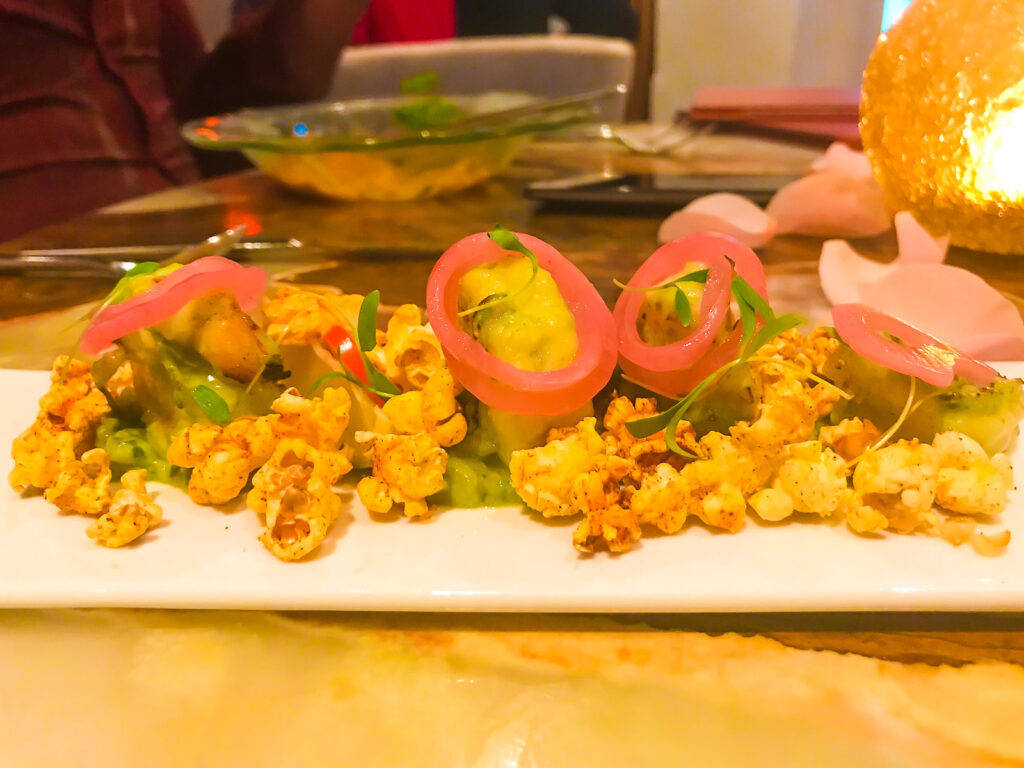 colorful shrimp appetizer with pickled vegetables and seasoned popcorn at Marmalade PR restaurant.