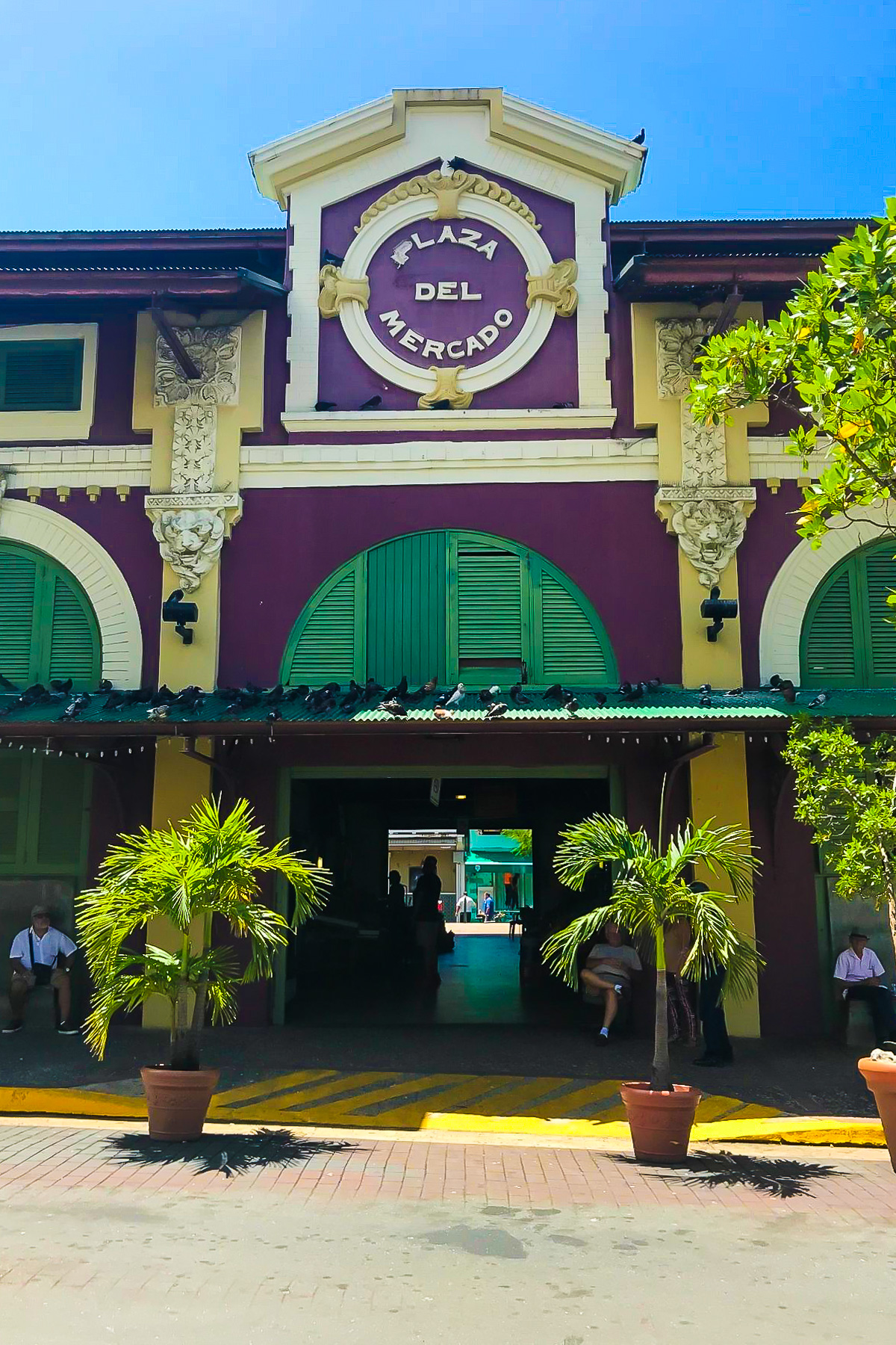 red, green, and yellow painted facade of Plaza del Mercado in San Juan, Puerto Rico.