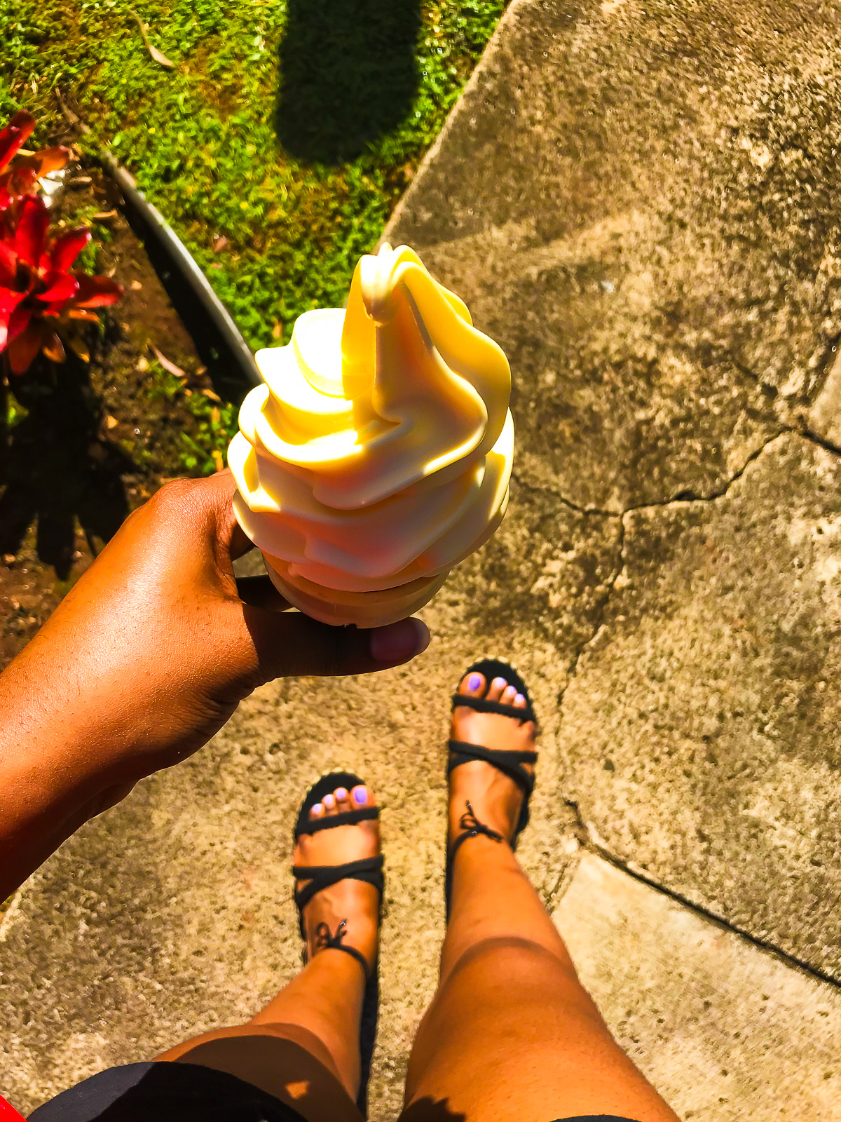 Jazzmine holding a cone of Dole pineapple whip in Hawaii.