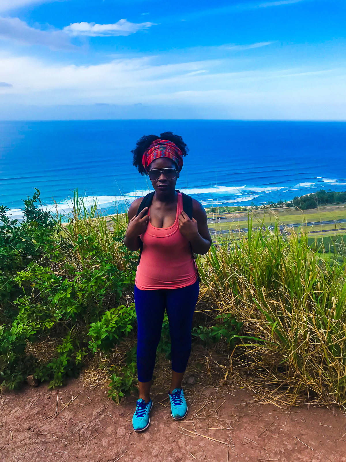 Jazzmine standing at lookout point along Kealia Trail in Mokuleia, Hawaii, during Oahu Hawaii solo travel.