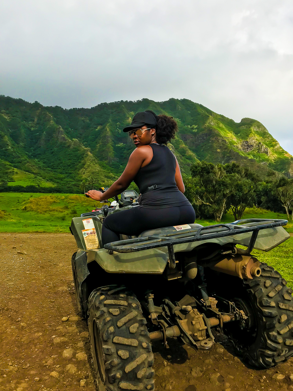 Jazzmine looking over shoulder while driving an ATV at Kualoa Ranch in Oahu, Hawaii.