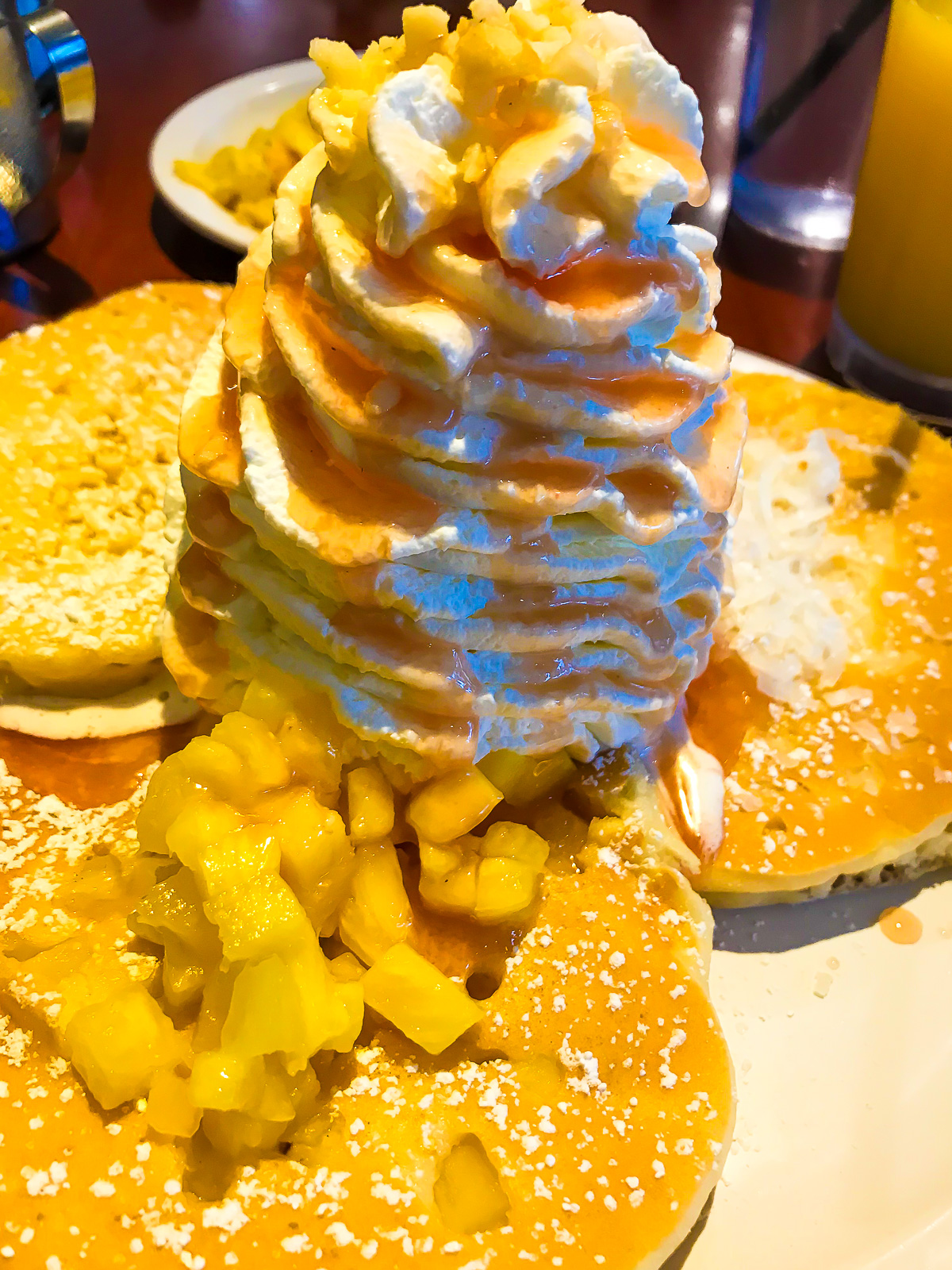 whipped pancake sampler with pineapple whipped cream and guava syrup at Eggs n Things near Waikiki Beach, Oahu, Hawaii.