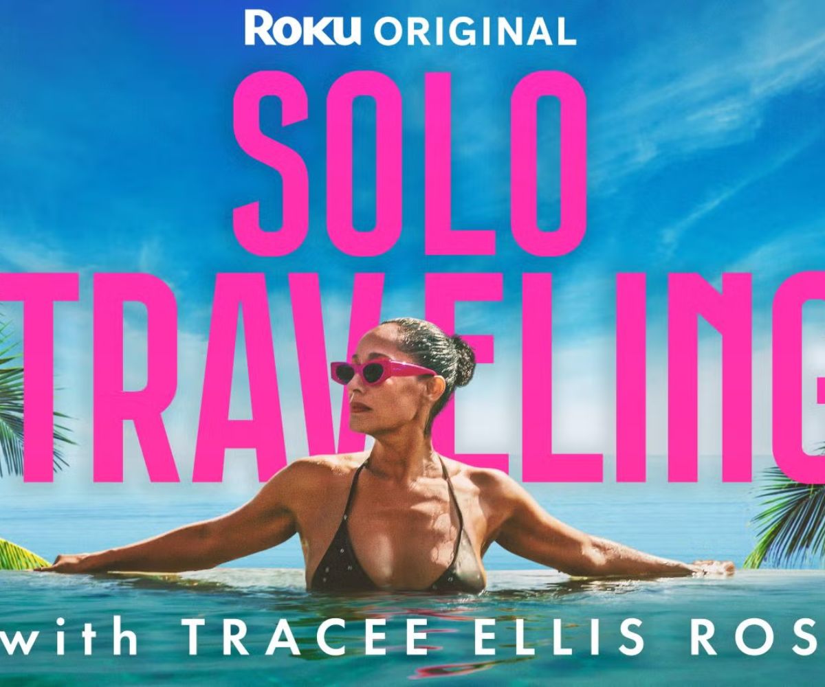 Tracee Ellis Ross lounging in a resort pool in Mexico wearing pink sunglasses and a black bikini with text overlay that reads "Roku Original Solo Traveling with Tracee Ellis Ross".
