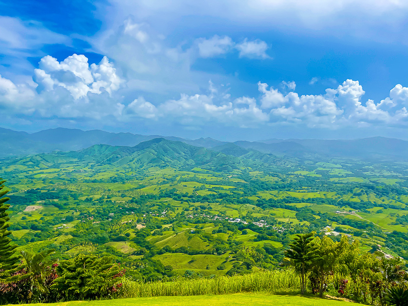 stunning view of Miches and nearby lush green mountain range from the top of Montaña Redonda in the Dominican Republic.
