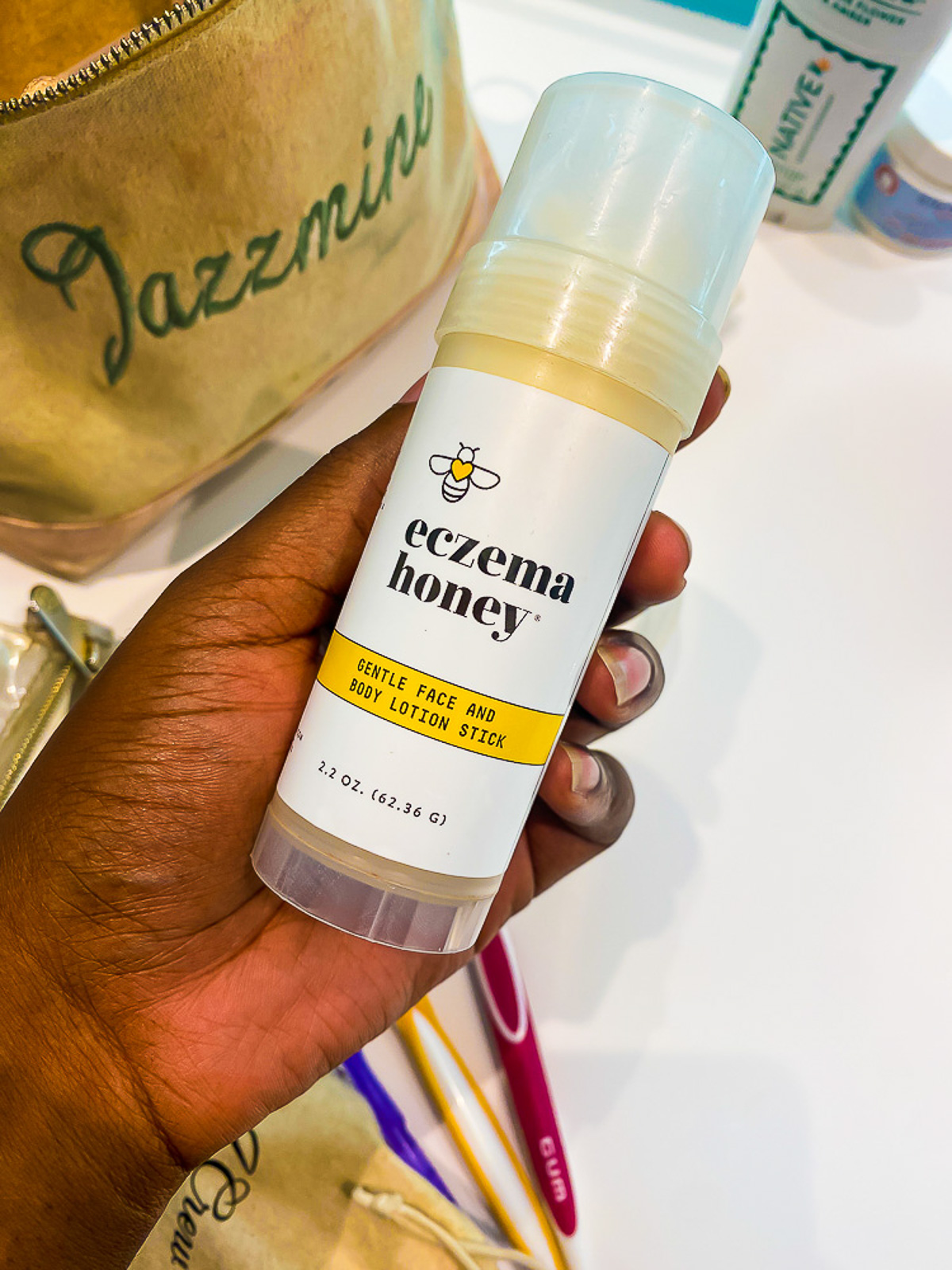 brown hand holding lotion stick from Dominican Republic resort packing list.