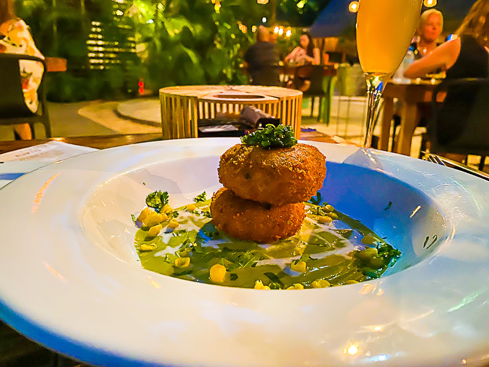 Lion fish cakes and Golondrina cocktail on outdoor table at Kondesa restaurant in Cozumel, Quintana Roo, Mexico.