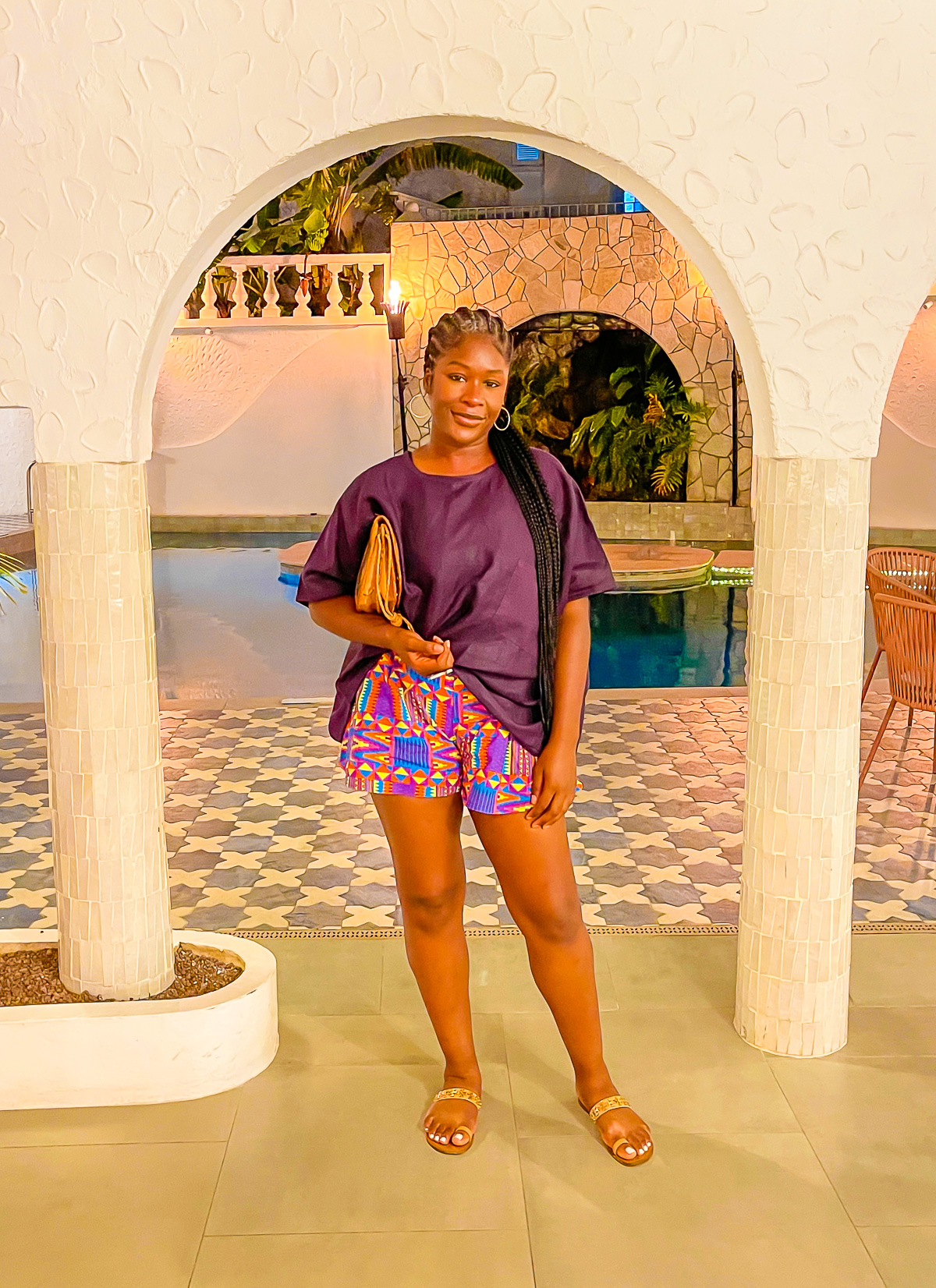 Jazzmine dressed for dinner at The Flying Fish in Morne Rouge, St. George parish, Grenada, wearing a purple wax print top and kente printed shorts.