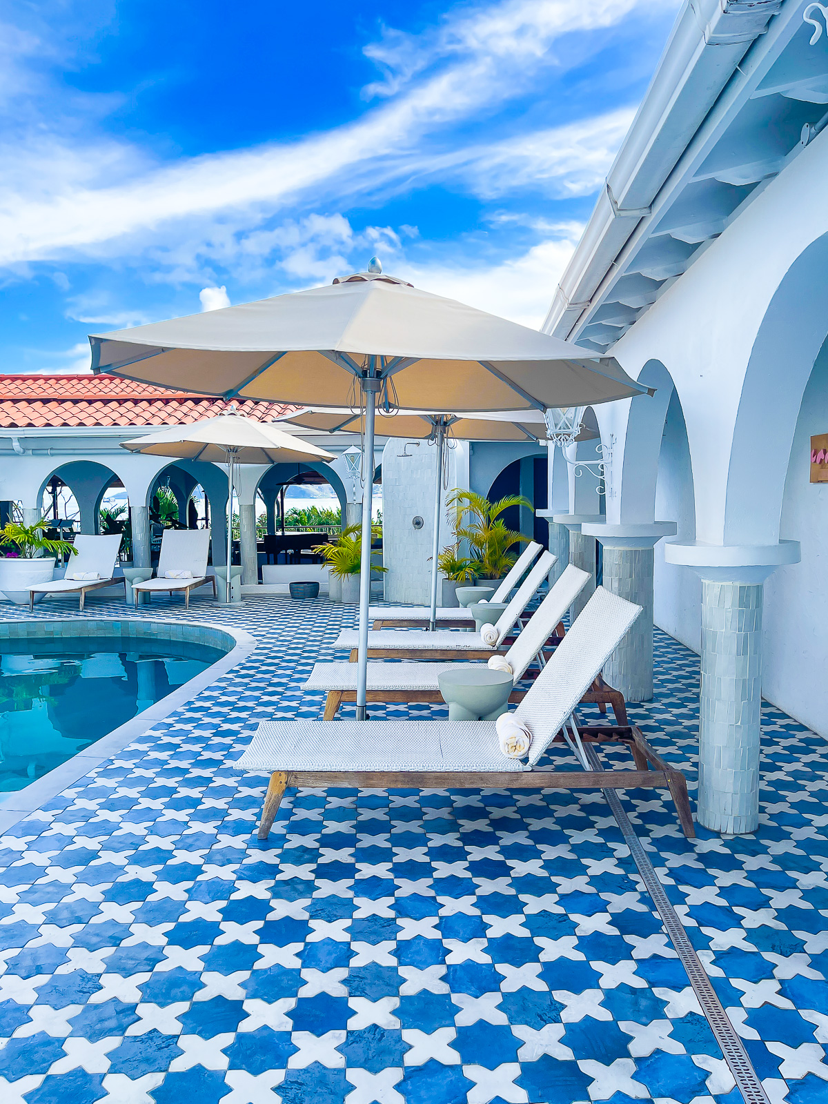 Mediterranean-inspired pool deck at Mount Cinnamon Beach and Wellness Resort Grenada.
