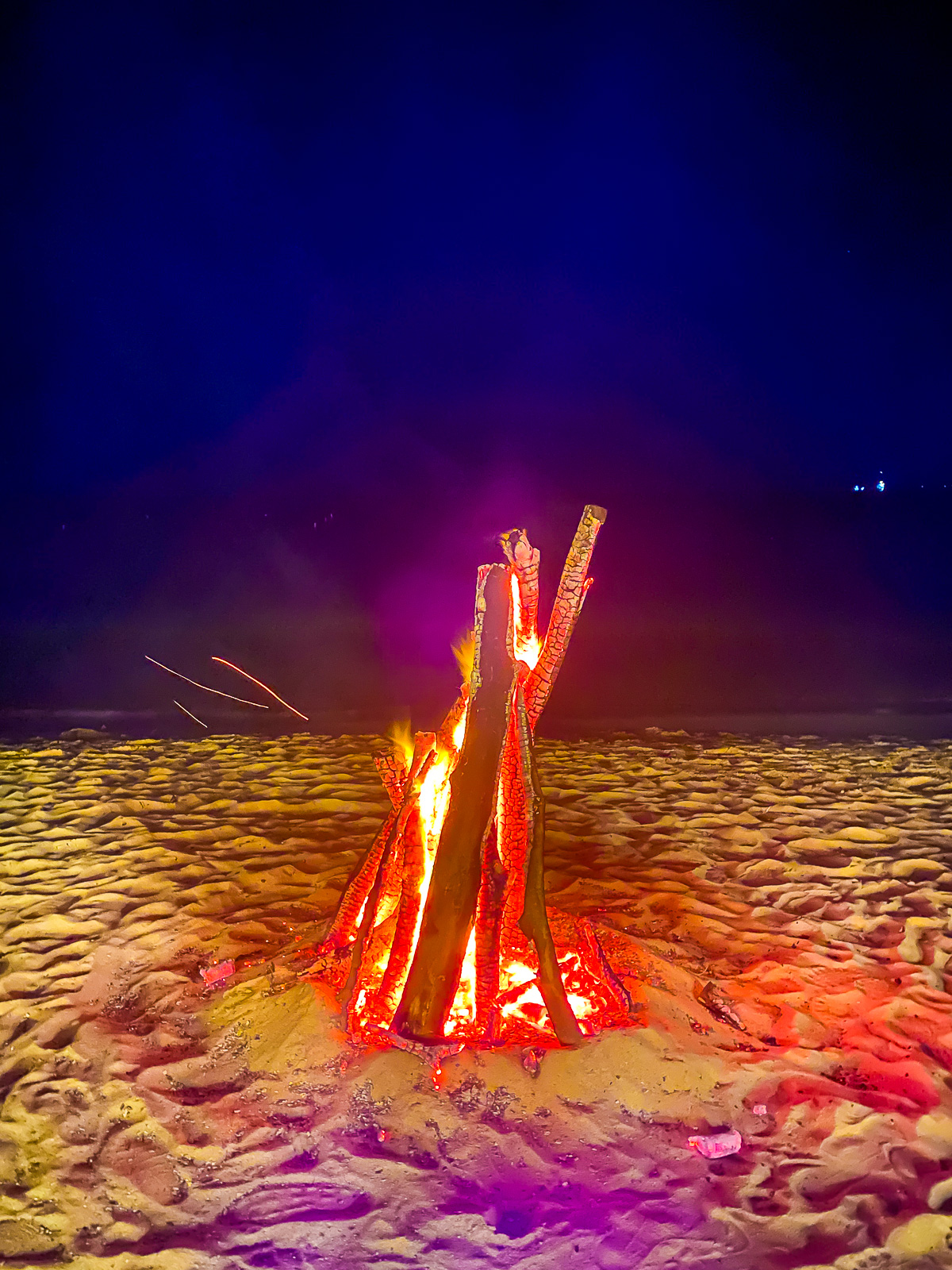 blazing nighttime beach bonfire at Savvy's Bar & Grill at Mount Cinnamon Beach Resort & Spa in Grenada.