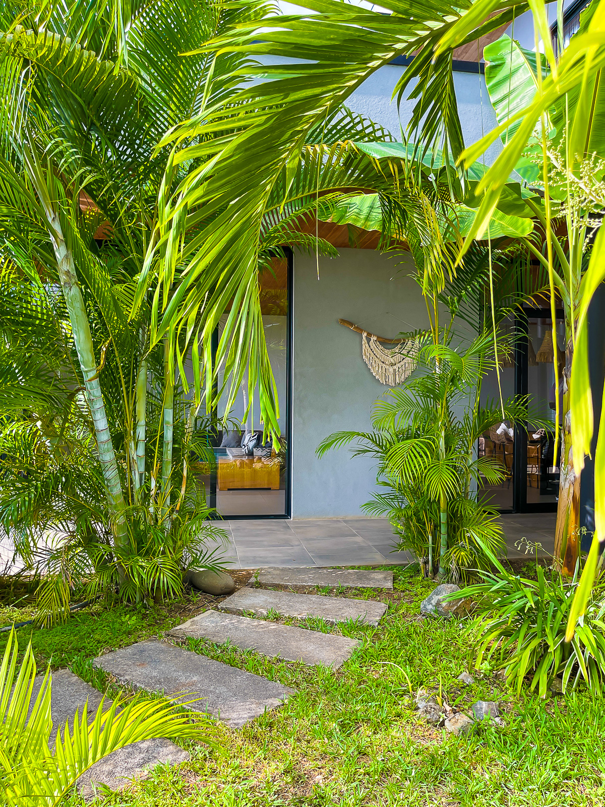 lush entrance to a vacation rental home and kitchen in the Tamahills community in Tamarindo, CR.