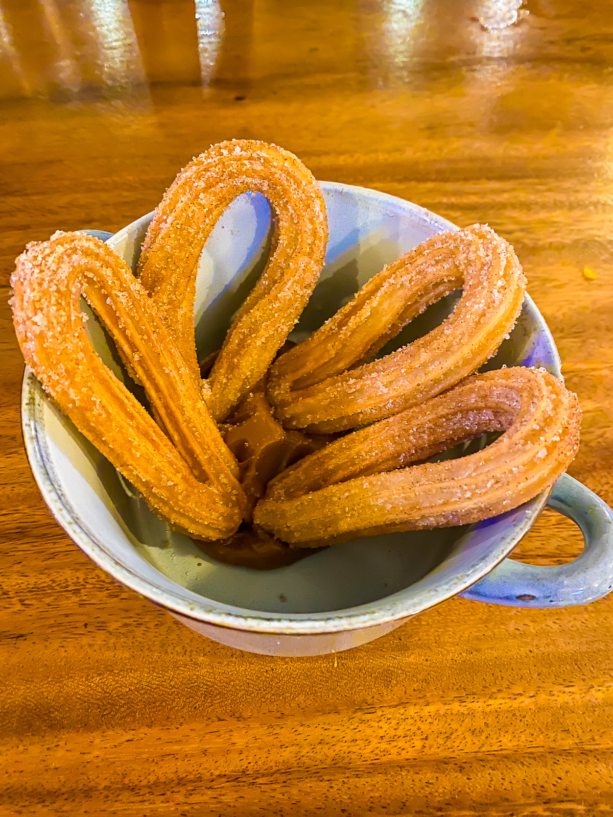 order of four churros in cajeta caramel served at Little Lucha in Tamarindo.