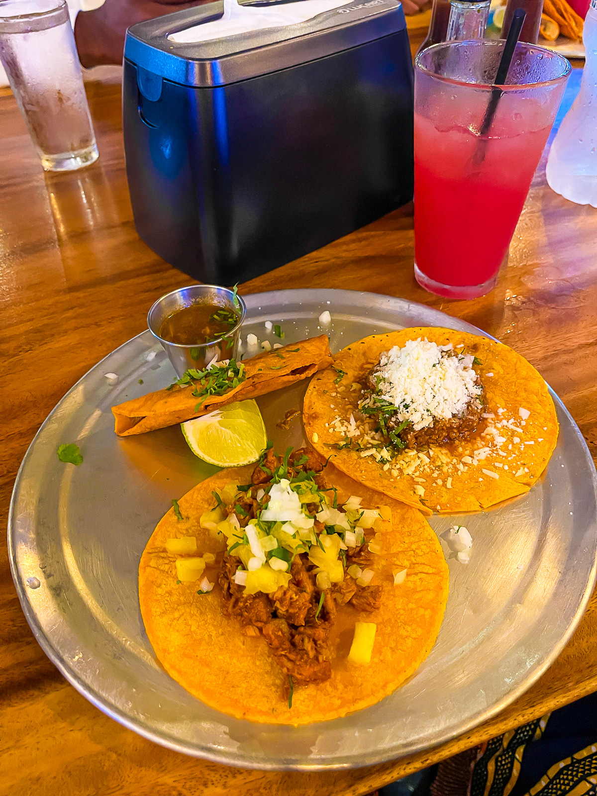 plate of tacos and glass of hibiscus agua fresca at Little Lunch in Tamarindo, Costa Rica.