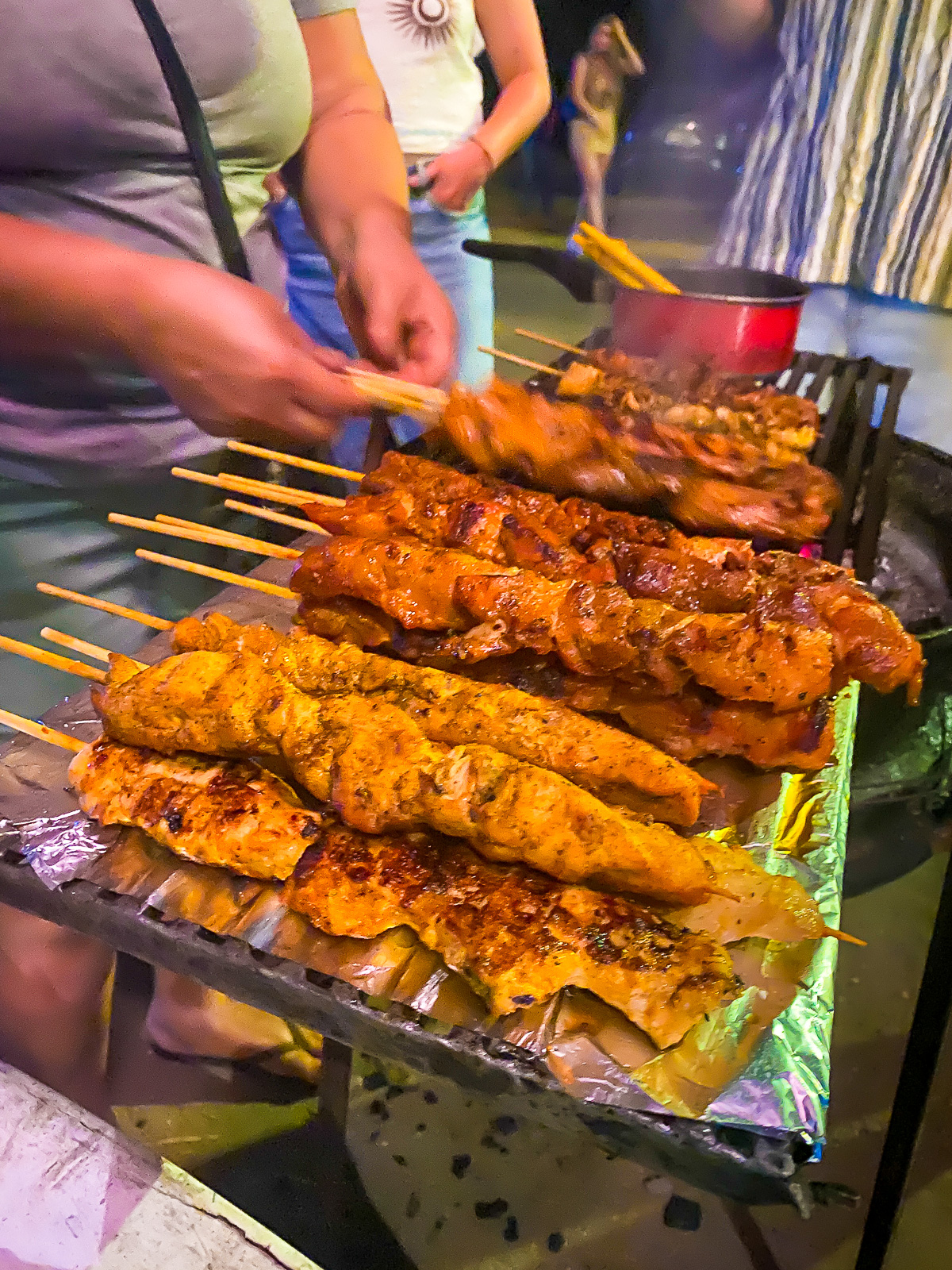 hot pinchos cooking on a portable grill outside Crazy Monkey nightclub in Tamarindo, Costa Rica.